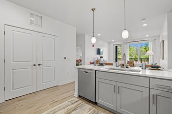 A modern kitchen with white cabinets and a large island.